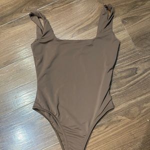 brown body suit